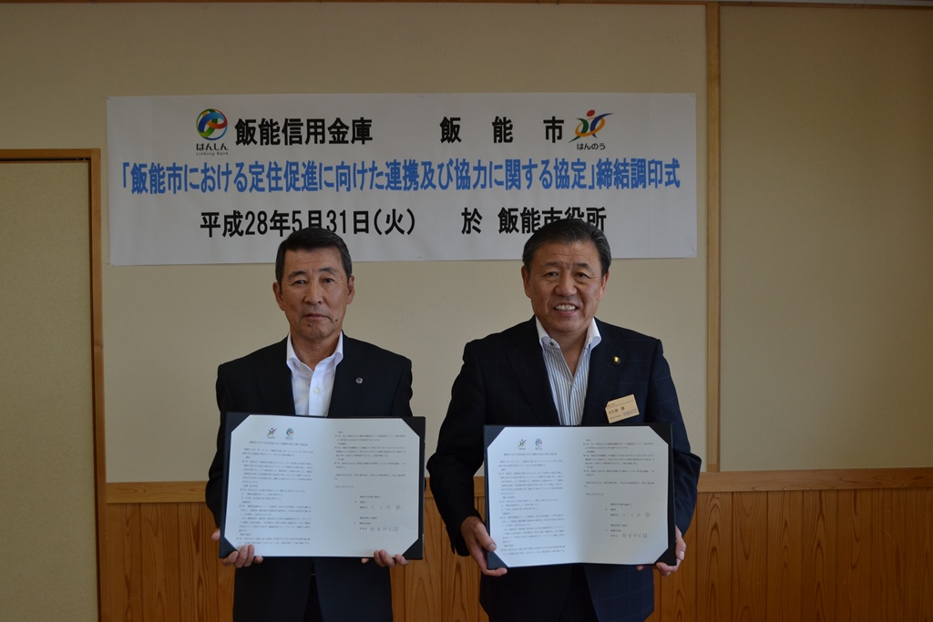 市長と、飯能信用金庫理事長が協定書を手に持ち並んで撮影している写真